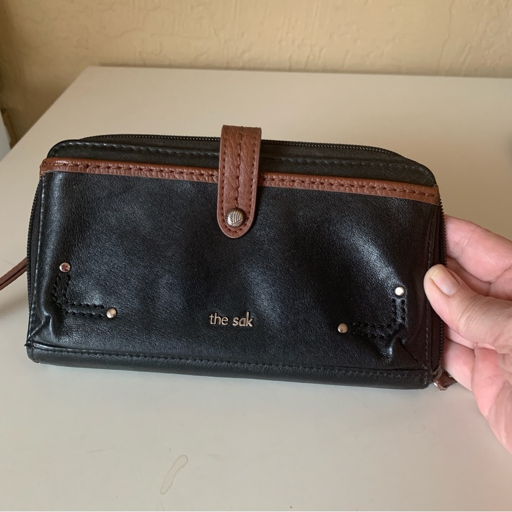 The Sak Black and Brown Leather Wallet with Strap Closure